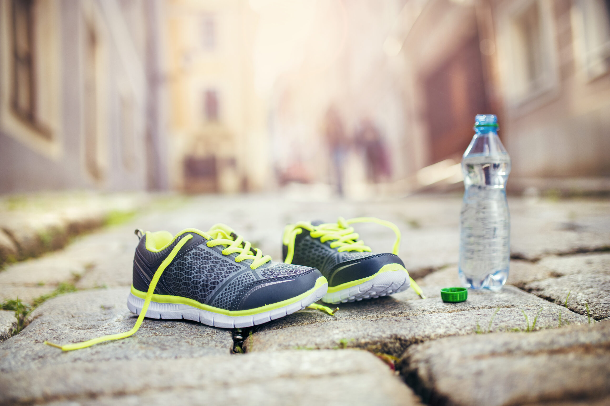 graphicstock-running-shoes-and-bottle-of-water-left-on-tiled-pavement-in-old-city-center_BCbitobhWb-scaled Lose Weight Safely: The Best Advice from Experts for Long-Term Success